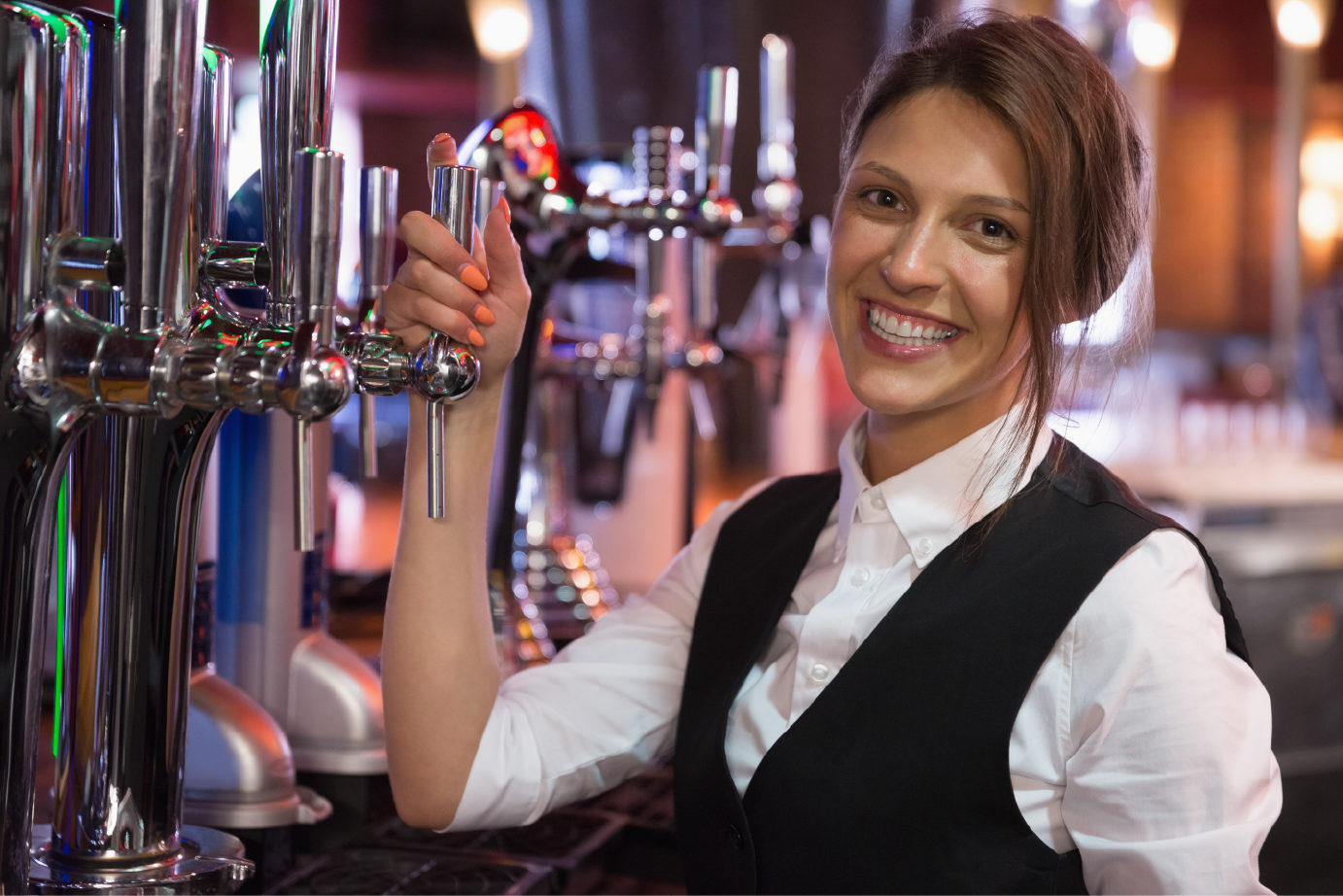 Woman holding a tap in a bar