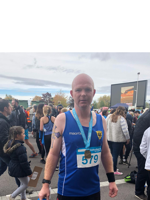 Man with medal after completing marathon