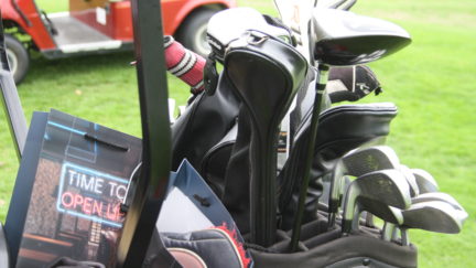 Photo of golf clubs and Licensed Trade Charity merchandise