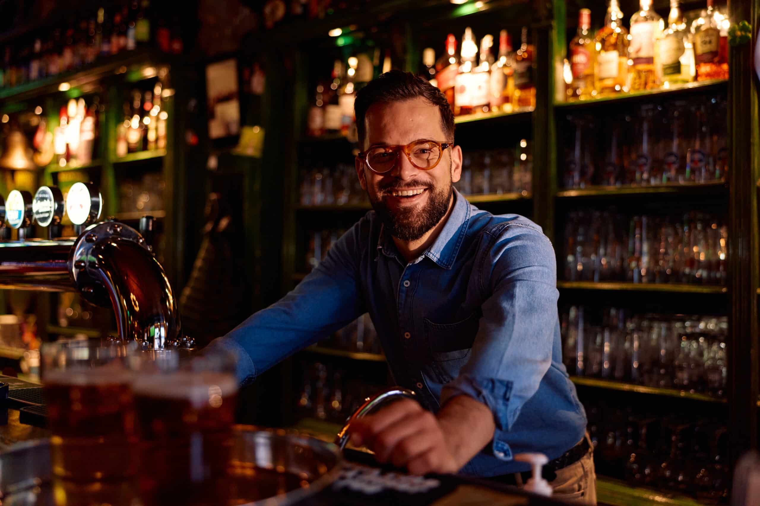 Smiling bartender in pub