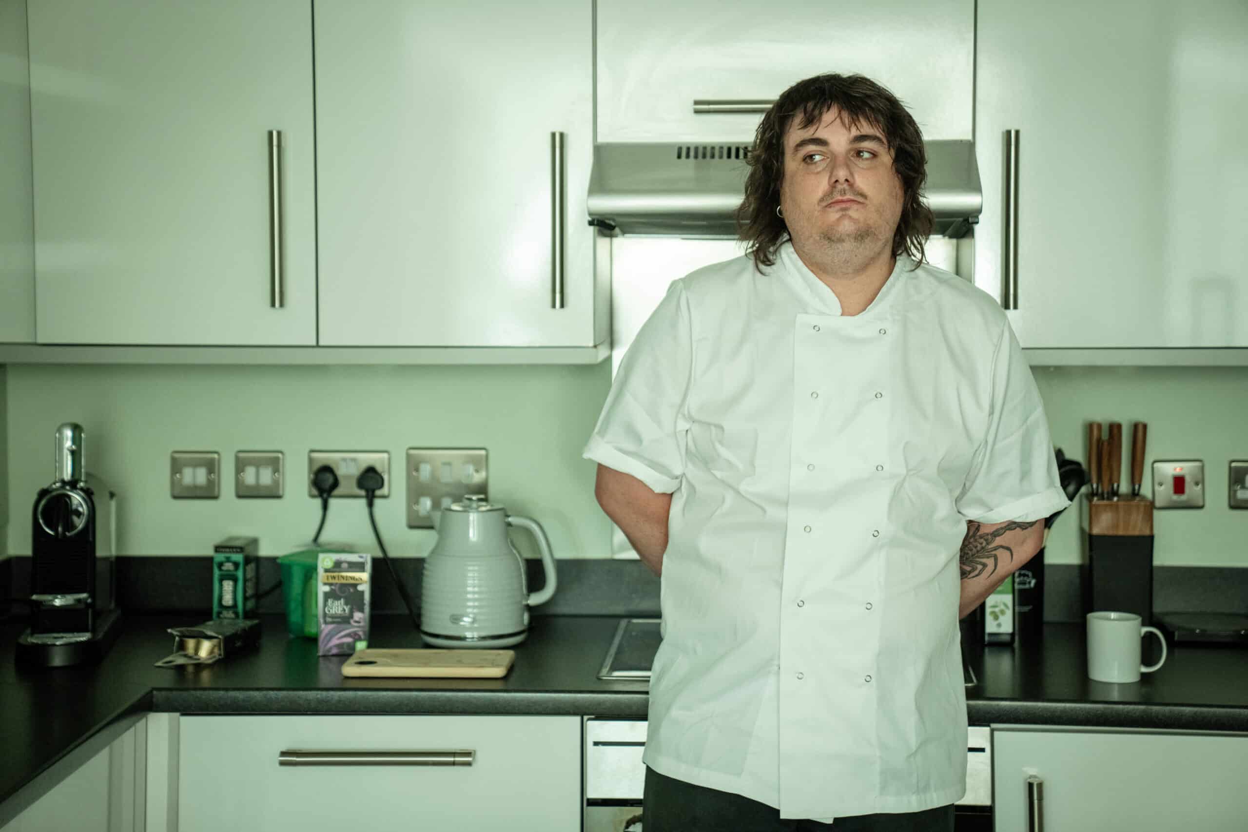 Chef in white uniform in a modern kitchen, always on shift